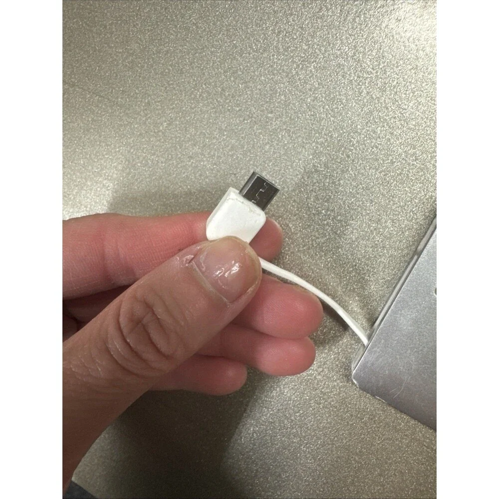 Ultra Slim portable charger silver with looks like Micro-USB cord see photos